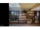 A cozy living room featuring custom shelving, wooden shutters, a skylight, and decorative plants that add natural charm at 498 W Gail Dr, Chandler, AZ 85225