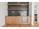 Stylish bar features a beverage cooler, wood cabinetry, granite countertop, and floating shelves at 5301 N 43Rd St, Phoenix, AZ 85018