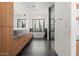Contemporary bathroom features marble shower, tile floors, a soaking tub, wood cabinetry, and picturesque window views at 5301 N 43Rd St, Phoenix, AZ 85018