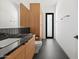 Contemporary bathroom with black and grey marble countertops, tile floors, and wood vanity at 5301 N 43Rd St, Phoenix, AZ 85018