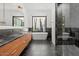 Elegant bathroom features a soaking tub, marble shower, wood cabinetry, and picturesque window views at 5301 N 43Rd St, Phoenix, AZ 85018