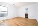 Bright bedroom with hardwood floors and a view into an ensuite bathroom at 5301 N 43Rd St, Phoenix, AZ 85018