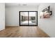 Living room with hardwood floors, a wall-mounted television and access to the pool at 5301 N 43Rd St, Phoenix, AZ 85018