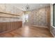 Stylish office with wood floors, built-in cabinets, shelves, and accent wall, offering a sophisticated workspace at 5301 N 43Rd St, Phoenix, AZ 85018