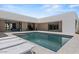 Modern home featuring a sleek pool with tanning deck, lounge chairs, and a connected indoor/outdoor living space at 5301 N 43Rd St, Phoenix, AZ 85018
