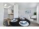 Modern dining area with a view into the living room and updated kitchen at 616 S Hardy Dr # 203, Tempe, AZ 85281