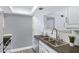 Modern kitchen with white cabinetry, sleek countertops, and stainless-steel appliances at 616 S Hardy Dr # 203, Tempe, AZ 85281