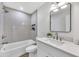 Modern bathroom featuring a stylish vanity with framed mirror and updated tub at 6415 S Newberry Rd # A, Tempe, AZ 85283