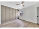 Spacious bedroom featuring wood-look floors, a modern ceiling fan, and plenty of natural light at 6415 S Newberry Rd # A, Tempe, AZ 85283