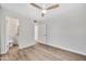 Cozy bedroom featuring light floors, a modern ceiling fan, and nearby bathroom at 6415 S Newberry Rd # A, Tempe, AZ 85283