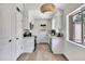 Bright kitchen with white cabinetry, stainless steel appliances, and a view of the back patio at 6415 S Newberry Rd # A, Tempe, AZ 85283