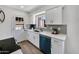 Well-lit kitchen with white cabinets, modern appliances, light countertops, and backyard access at 6415 S Newberry Rd # A, Tempe, AZ 85283