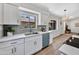 Modern kitchen featuring white cabinets, a stylish backsplash, and stainless steel appliances at 6415 S Newberry Rd # A, Tempe, AZ 85283