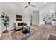 Cozy living room with modern decor, a ceiling fan, light wood flooring, and a view of the kitchen at 6415 S Newberry Rd # A, Tempe, AZ 85283