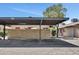 A covered parking area with marked spaces and a brick wall, providing shade and protection for vehicles at 6415 S Newberry Rd # A, Tempe, AZ 85283