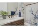 Bathroom vanity featuring decorative shower curtain, mirror and blue accent towels at 6450 E Monterra Way, Scottsdale, AZ 85266