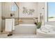 Bright bathroom featuring a soaking tub, walk-in shower, and decorative floral accents at 6450 E Monterra Way, Scottsdale, AZ 85266