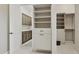 Organized walk-in closet and built-in shelving with attached laundry area in neutral tones at 6450 E Monterra Way, Scottsdale, AZ 85266