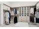 Spacious walk-in closet with custom shelving, hanging rods and drawers at 6450 E Monterra Way, Scottsdale, AZ 85266