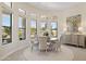 Bright dining room features large windows, elegant chandelier, and neutral decor at 6450 E Monterra Way, Scottsdale, AZ 85266