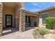 Welcoming front porch with stone columns and a cozy seating area, ideal for enjoying the outdoors at 6450 E Monterra Way, Scottsdale, AZ 85266