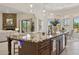 Bright open kitchen features a large island with granite countertops and modern pendant lighting at 6450 E Monterra Way, Scottsdale, AZ 85266