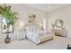 Bright main bedroom with neutral colors, carpet floors, and a decorative tree near the window at 6450 E Monterra Way, Scottsdale, AZ 85266