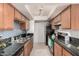 Well-lit kitchen with granite counters, mosaic backsplash, and appliances at 740 W Elm St # 266, Phoenix, AZ 85013