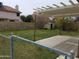 Large, grassy backyard featuring a covered patio, storage shed, and block wall fence at 7537 W Dreyfus Dr, Peoria, AZ 85381