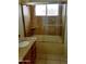 Bathroom featuring a sink with granite countertop and a tiled shower with glass door at 7537 W Dreyfus Dr, Peoria, AZ 85381