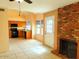 Open-concept living room with fireplace, adjacent to the kitchen and dining area at 7537 W Dreyfus Dr, Peoria, AZ 85381