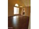 Open-concept living room featuring hardwood floors, a large window, and access to the kitchen at 7537 W Dreyfus Dr, Peoria, AZ 85381