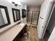 Bathroom featuring vanity, mirror, and shower with glass door at 8254 E Posada Ave, Mesa, AZ 85212