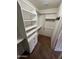 Walk-in closet featuring custom shelving, drawers, and ample storage space for organization at 8254 E Posada Ave, Mesa, AZ 85212