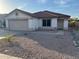 Charming single-story home featuring a tile roof, stucco siding, and low maintenance desert landscaping at 8254 E Posada Ave, Mesa, AZ 85212