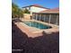 Beautiful backyard oasis with a sparkling pool surrounded by well-kept landscaping at 8254 E Posada Ave, Mesa, AZ 85212