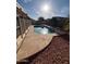 Backyard pool featuring unique stonework, small rocks, a handrail, and privacy fence at 8254 E Posada Ave, Mesa, AZ 85212