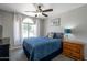 Bright bedroom with large window, ceiling fan, and a view to the front yard at 839 W Silver Creek Rd, Gilbert, AZ 85233