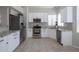 Bright kitchen features stainless steel appliances, white cabinets, and granite countertops at 839 W Silver Creek Rd, Gilbert, AZ 85233