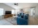 Inviting living room with a ceiling fan, tile floors, and natural light at 839 W Silver Creek Rd, Gilbert, AZ 85233