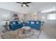 Comfortable living room with tile flooring, ceiling fan, and stylish decor at 839 W Silver Creek Rd, Gilbert, AZ 85233
