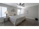 Cozy main bedroom features a ceiling fan, soft carpet, and ample natural light at 839 W Silver Creek Rd, Gilbert, AZ 85233