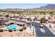Aerial view of the home community featuring a pool and mountain views at 8785 E Greenview Dr, Gold Canyon, AZ 85118