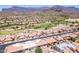 A picturesque aerial view of the townhome community and lush golf course against a mountain backdrop at 8785 E Greenview Dr, Gold Canyon, AZ 85118