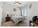 Cozy bedroom with a decorative clock, comfortable bed, and window overlooking outside at 8785 E Greenview Dr, Gold Canyon, AZ 85118