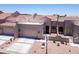 Inviting home exterior with a two-car garage, desert landscaping, and a gated entrance at 8785 E Greenview Dr, Gold Canyon, AZ 85118