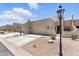 This townhome features a two-car garage, desert landscaping, and entry with an iron gate at 8785 E Greenview Dr, Gold Canyon, AZ 85118