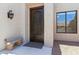 Beautifully crafted front door with decorative ironwork and a stone bench at 8785 E Greenview Dr, Gold Canyon, AZ 85118