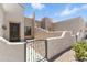 Charming front entrance featuring an iron gate and a stucco facade at 8785 E Greenview Dr, Gold Canyon, AZ 85118