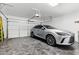 Clean garage space with epoxy flooring, an automatic door opener, and ample room for a car at 8785 E Greenview Dr, Gold Canyon, AZ 85118